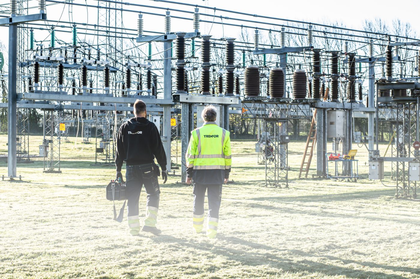 Field technicians walking an electrical substation